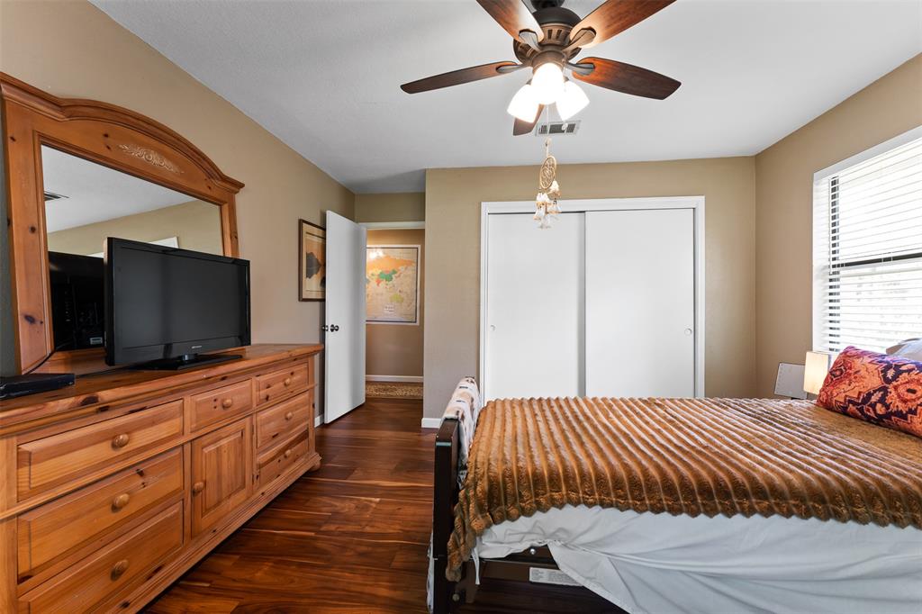 21013 Ridgeview Loop Lago Vista, TX 78645 - Photo 11 of 16 Bedroom featuring dark wood-style flooring, a closet, and a ceiling fan
