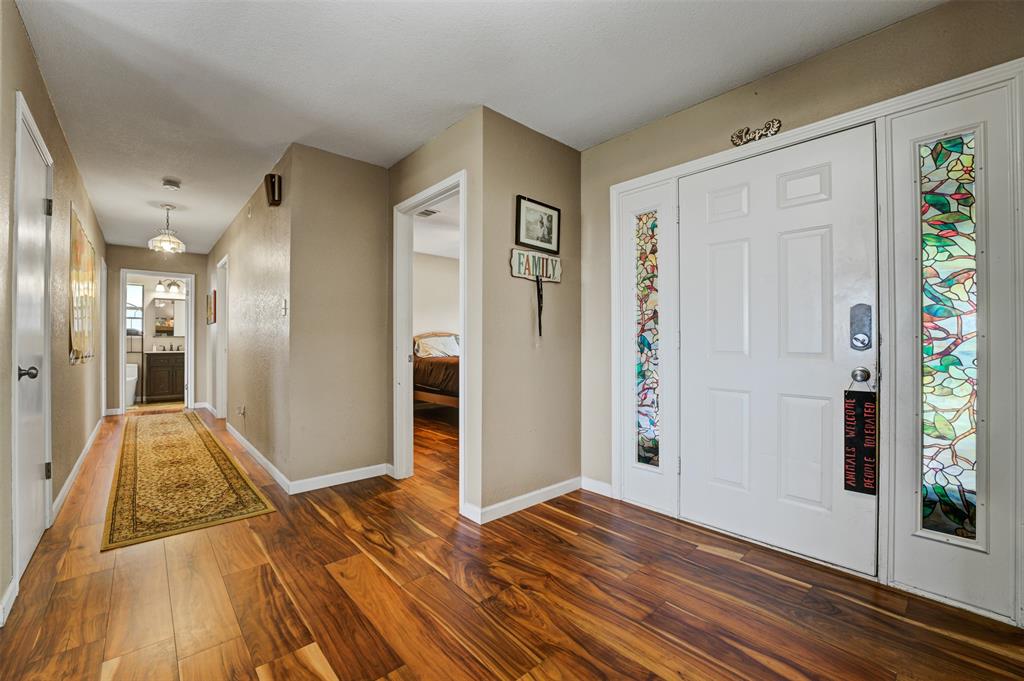 21013 Ridgeview Loop Lago Vista, TX 78645 - Photo 4 of 16 Foyer entrance with dark wood-style flooring and baseboards