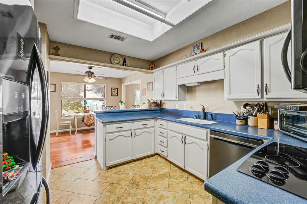 21013 Ridgeview Loop Lago Vista, TX 78645 - Photo 6 of 16 Spacious kitchen with white cabinets and Corian style countertops