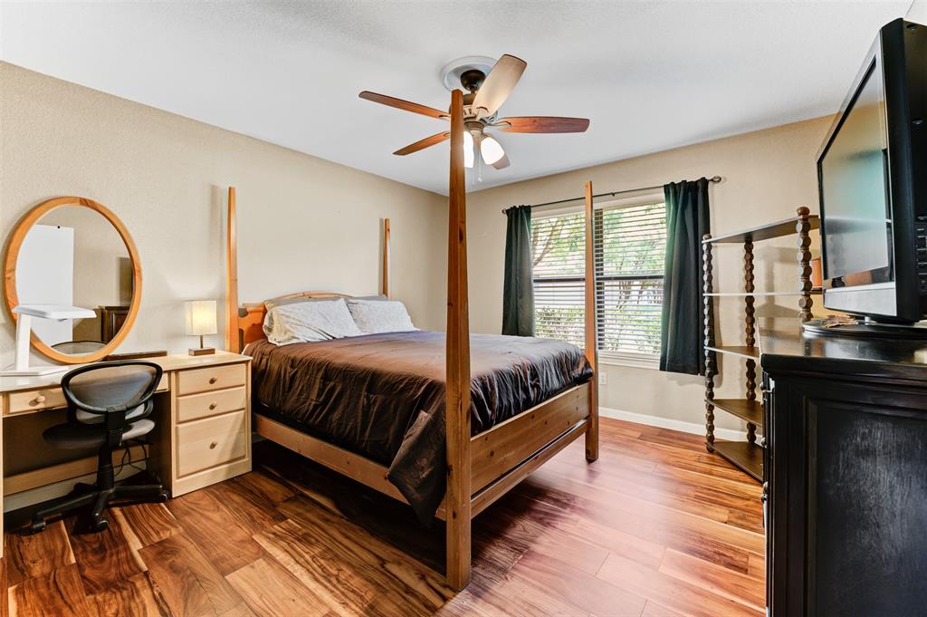 21013 Ridgeview Loop Lago Vista, TX 78645 - Photo 10 of 16 Bedroom featuring dark wood-style floors and a ceiling fan
