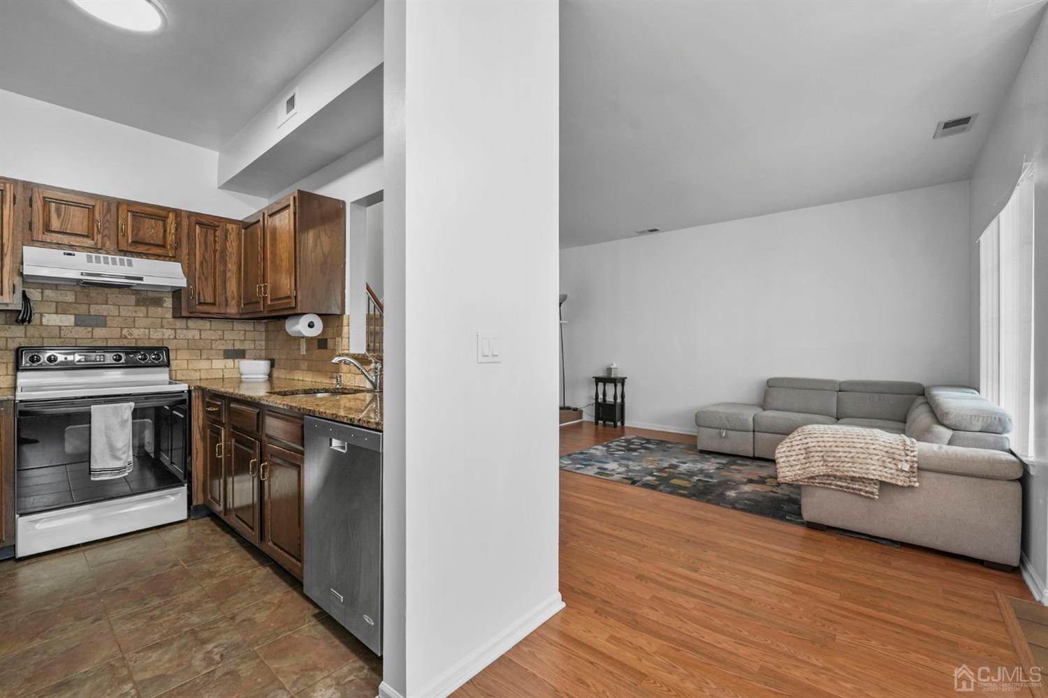 17 Bentley Court Bedminster, NJ 07921 - Photo 7 of 44 a view of kitchen and kitchen with furniture wooden floor and window
