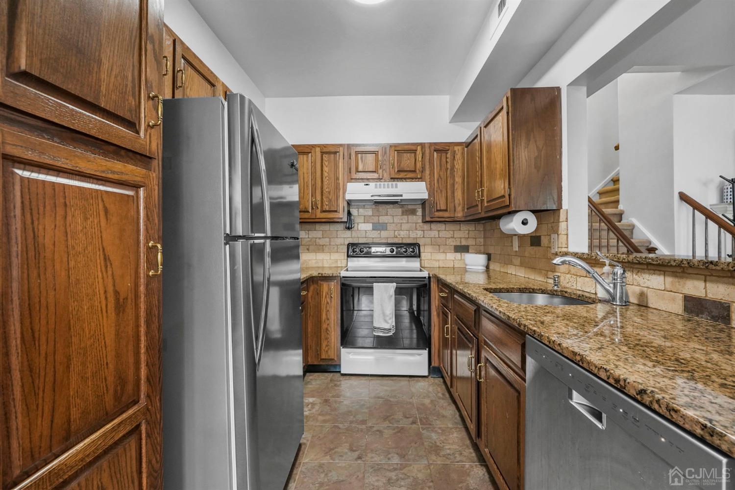 17 Bentley Court Bedminster, NJ 07921 - Photo 9 of 44 a kitchen with stainless steel appliances granite countertop a stove a sink and a refrigerator