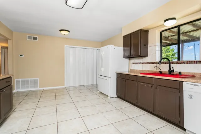 a kitchen with a sink cabinets and appliances