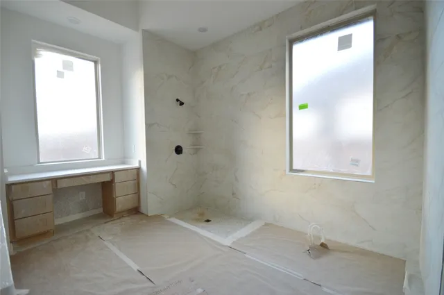 a bathroom with a bathtub and shower