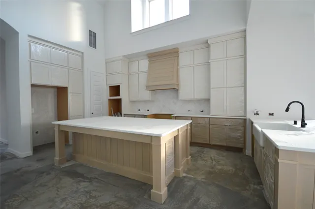 a kitchen with a sink stove and cabinets