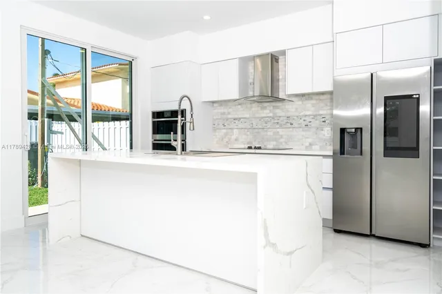 a kitchen with stainless steel appliances a refrigerator and a stove