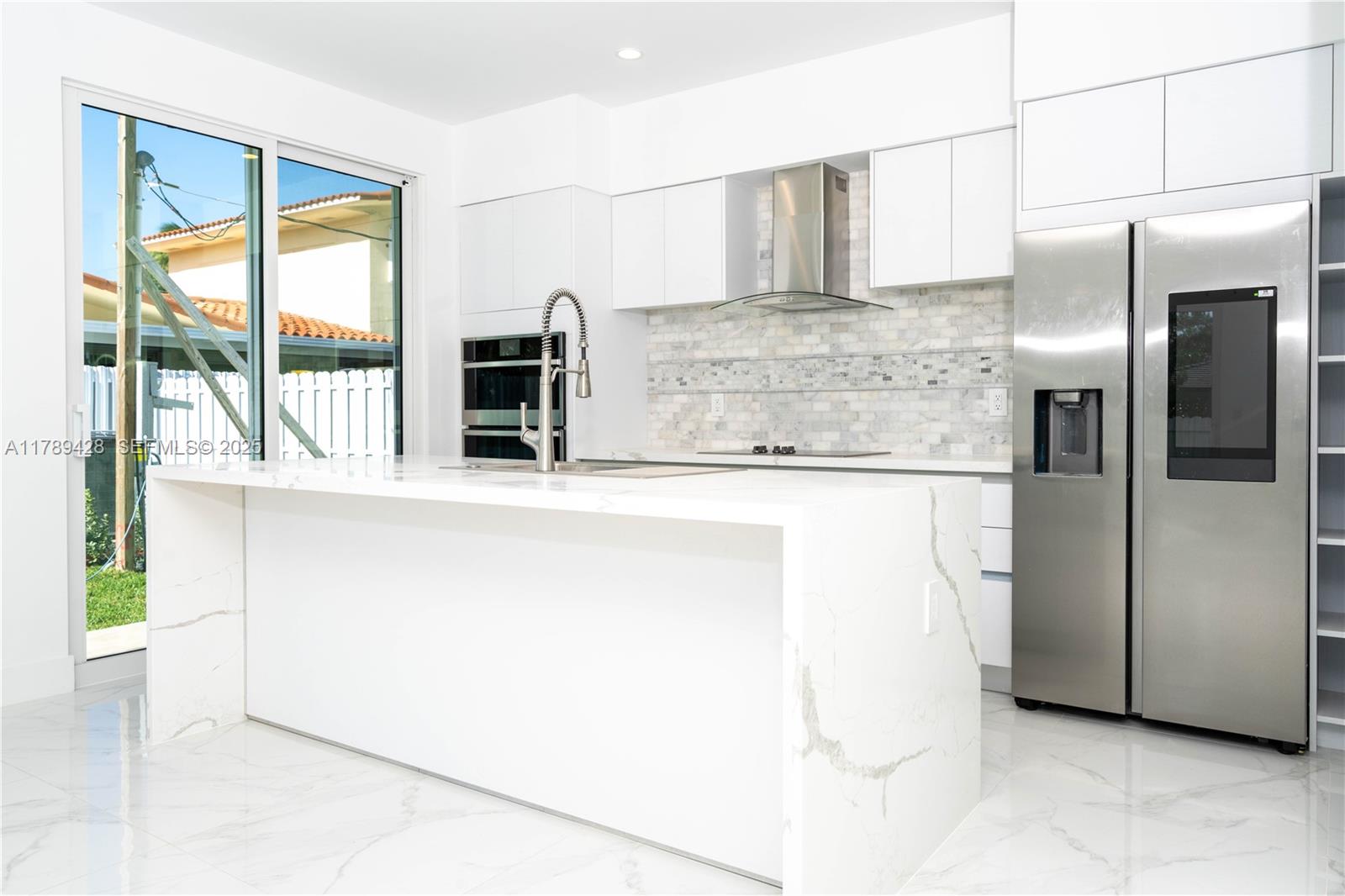 900 Southwest 24th Road Miami, FL 33129 - Photo 12 of 27 a kitchen with stainless steel appliances a refrigerator and a stove