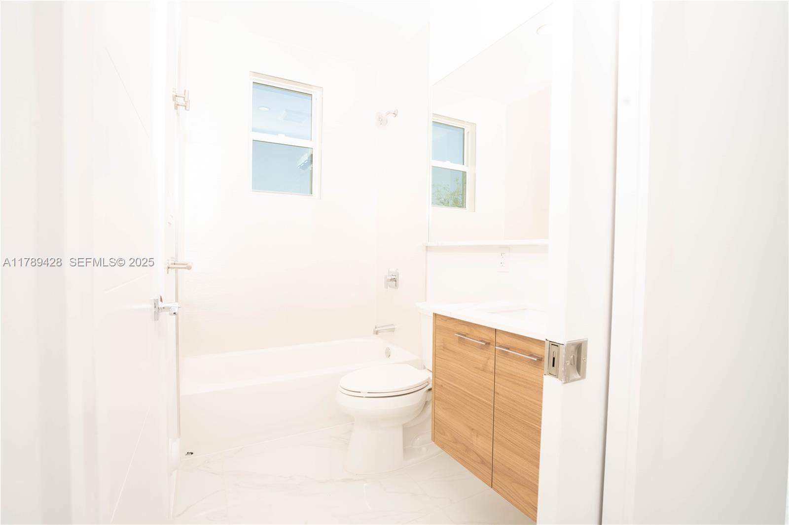 900 Southwest 24th Road Miami, FL 33129 - Photo 14 of 27 a bathroom with a toilet and a shower