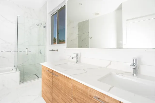 a bathroom with a sink a shower and a mirror