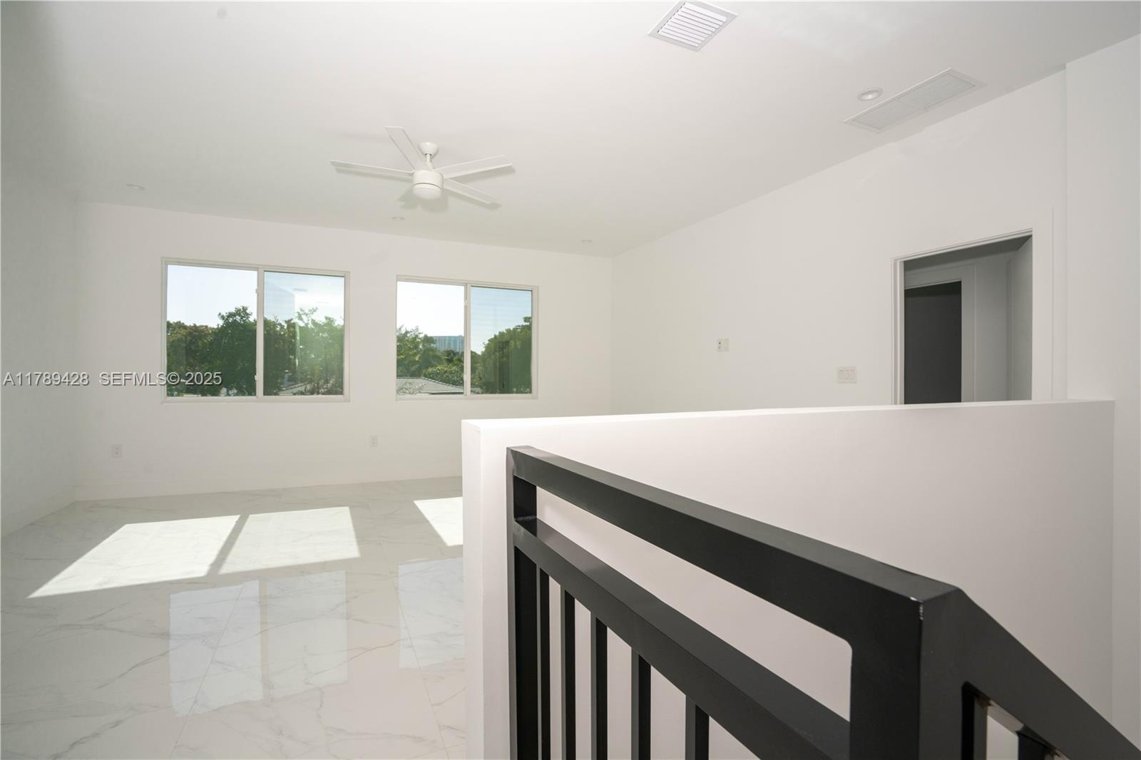 900 Southwest 24th Road Miami, FL 33129 - Photo 16 of 27 a view of an empty room with a window