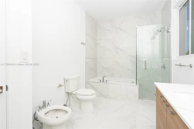a bathroom with a toilet a sink and bathtub