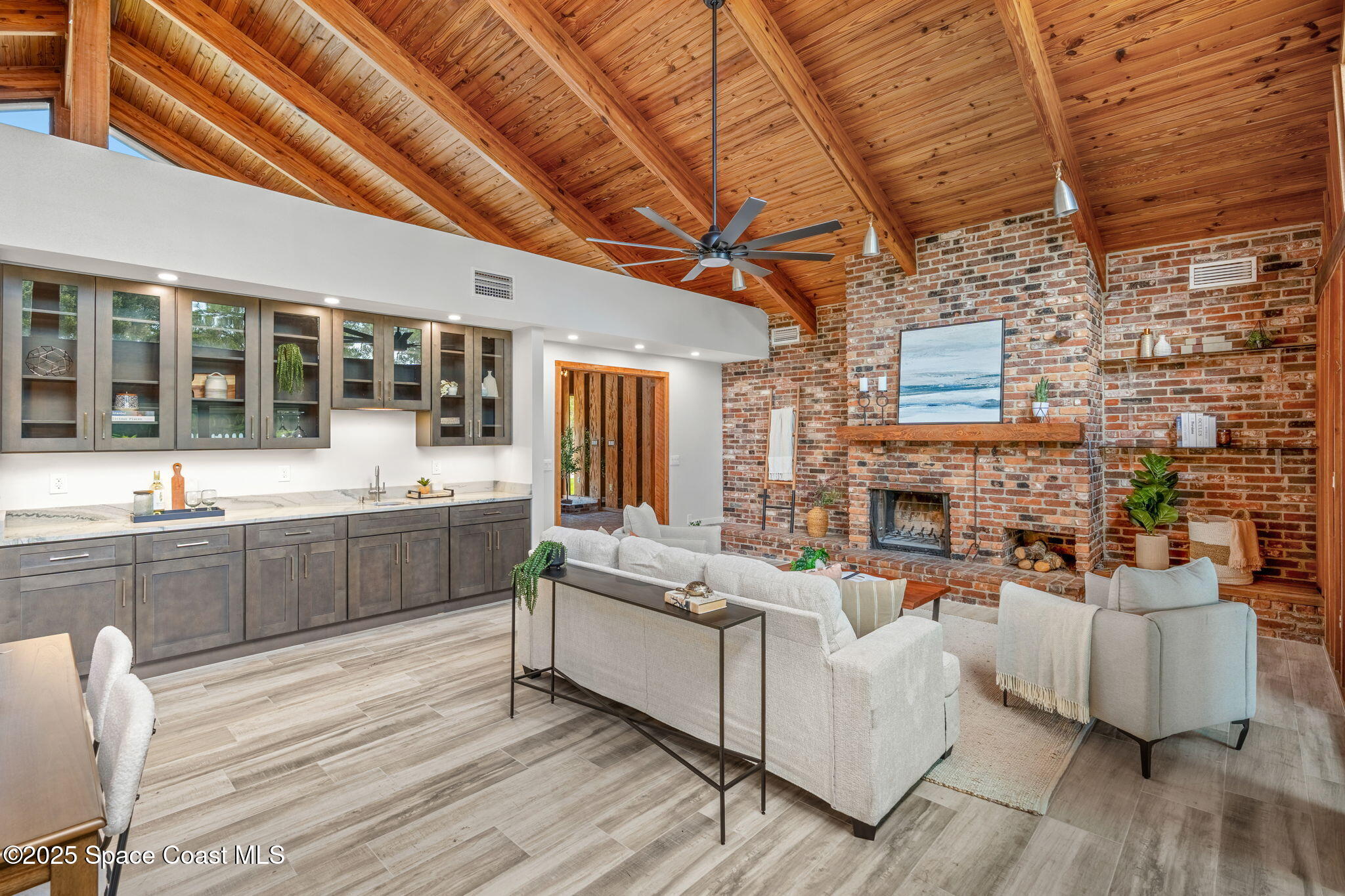 2187 Turtle Mound Road Melbourne, FL 32934 - Photo 19 of 77 a living room with furniture and a fireplace