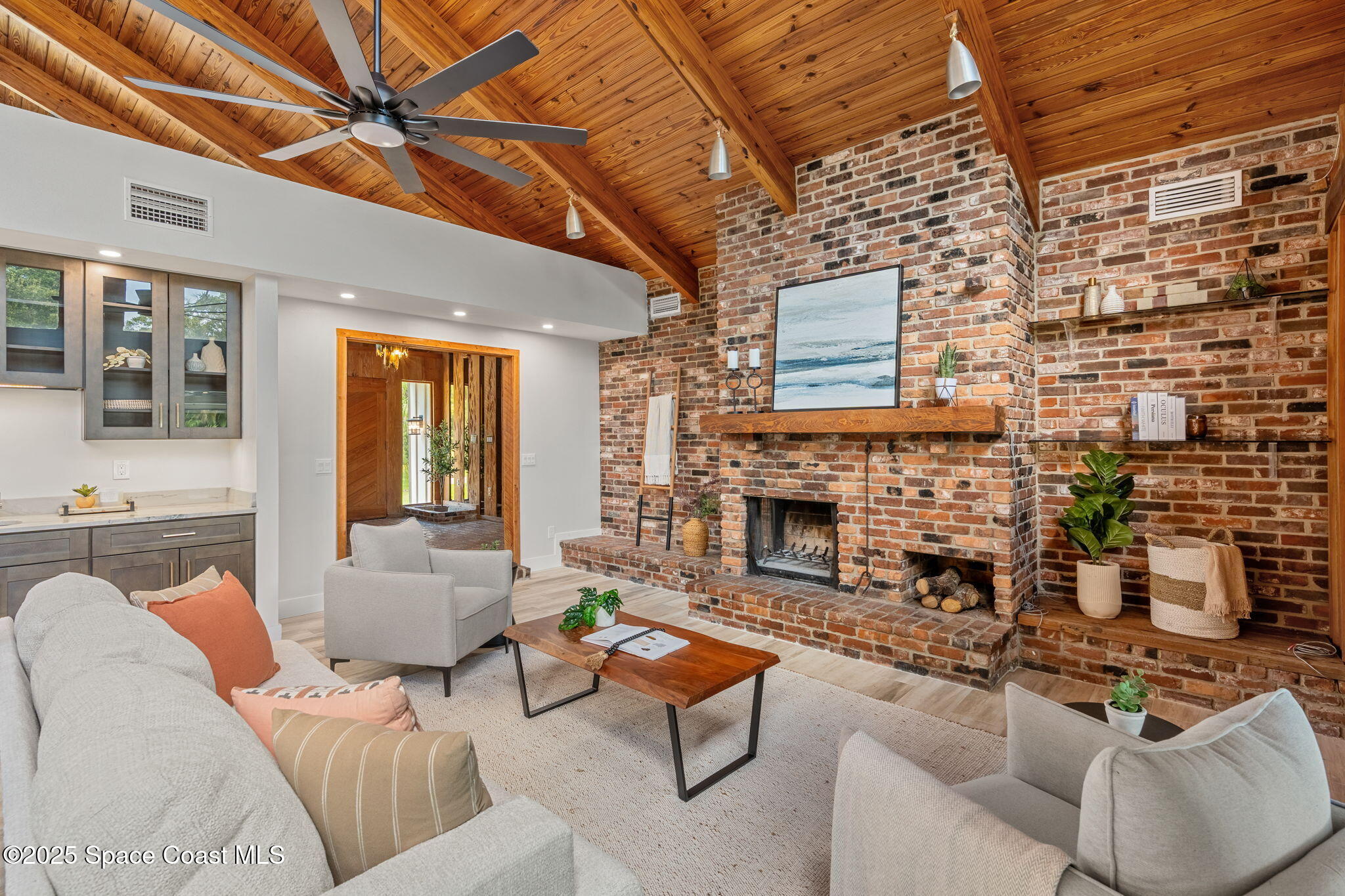 2187 Turtle Mound Road Melbourne, FL 32934 - Photo 21 of 77 a living room with furniture and a fireplace