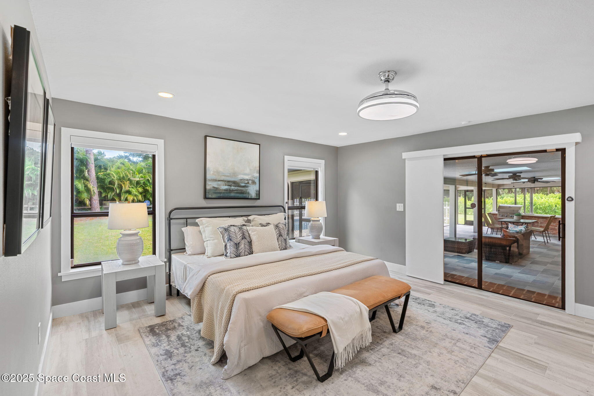 2187 Turtle Mound Road Melbourne, FL 32934 - Photo 31 of 77 a bedroom with a large bed and a large window