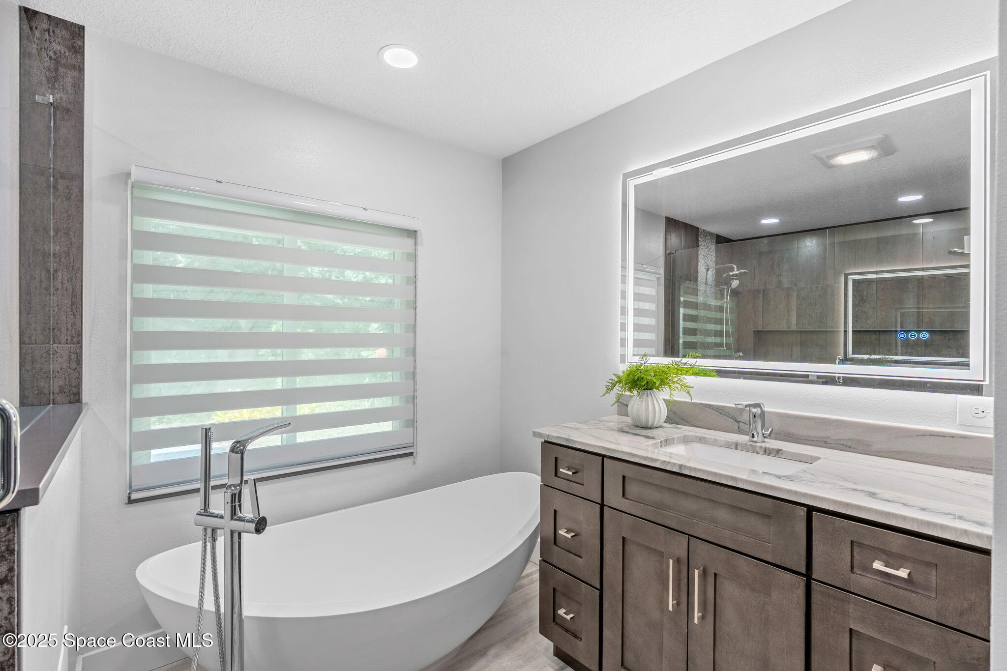 2187 Turtle Mound Road Melbourne, FL 32934 - Photo 34 of 77 a bathroom with a granite countertop sink and a window