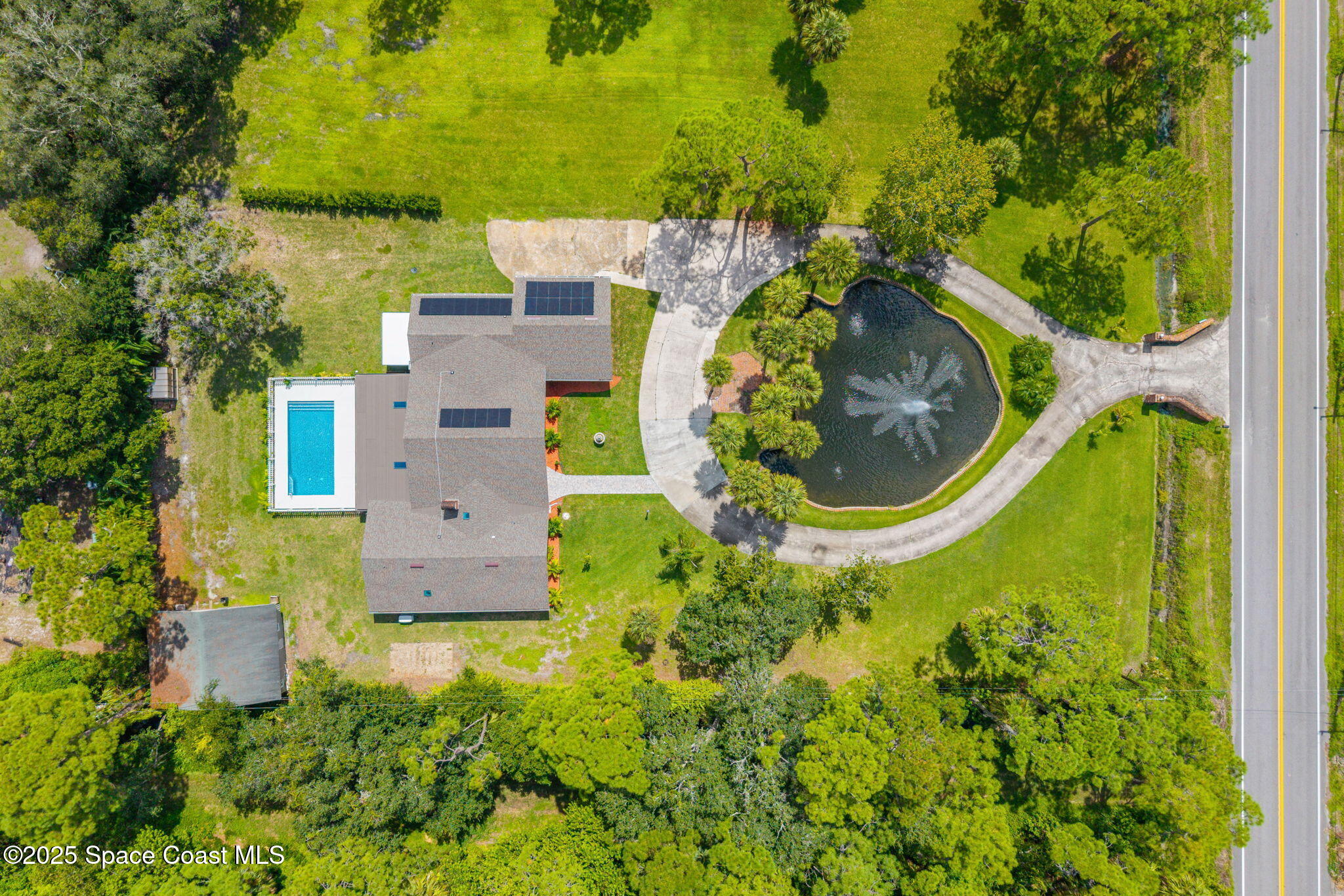 2187 Turtle Mound Road Melbourne, FL 32934 - Photo 4 of 77 an aerial view of residential house with outdoor space and trees all around