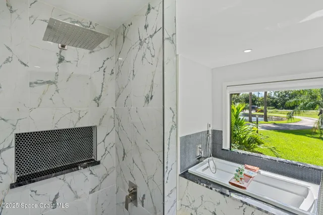 a view of a house with a yard and large trees