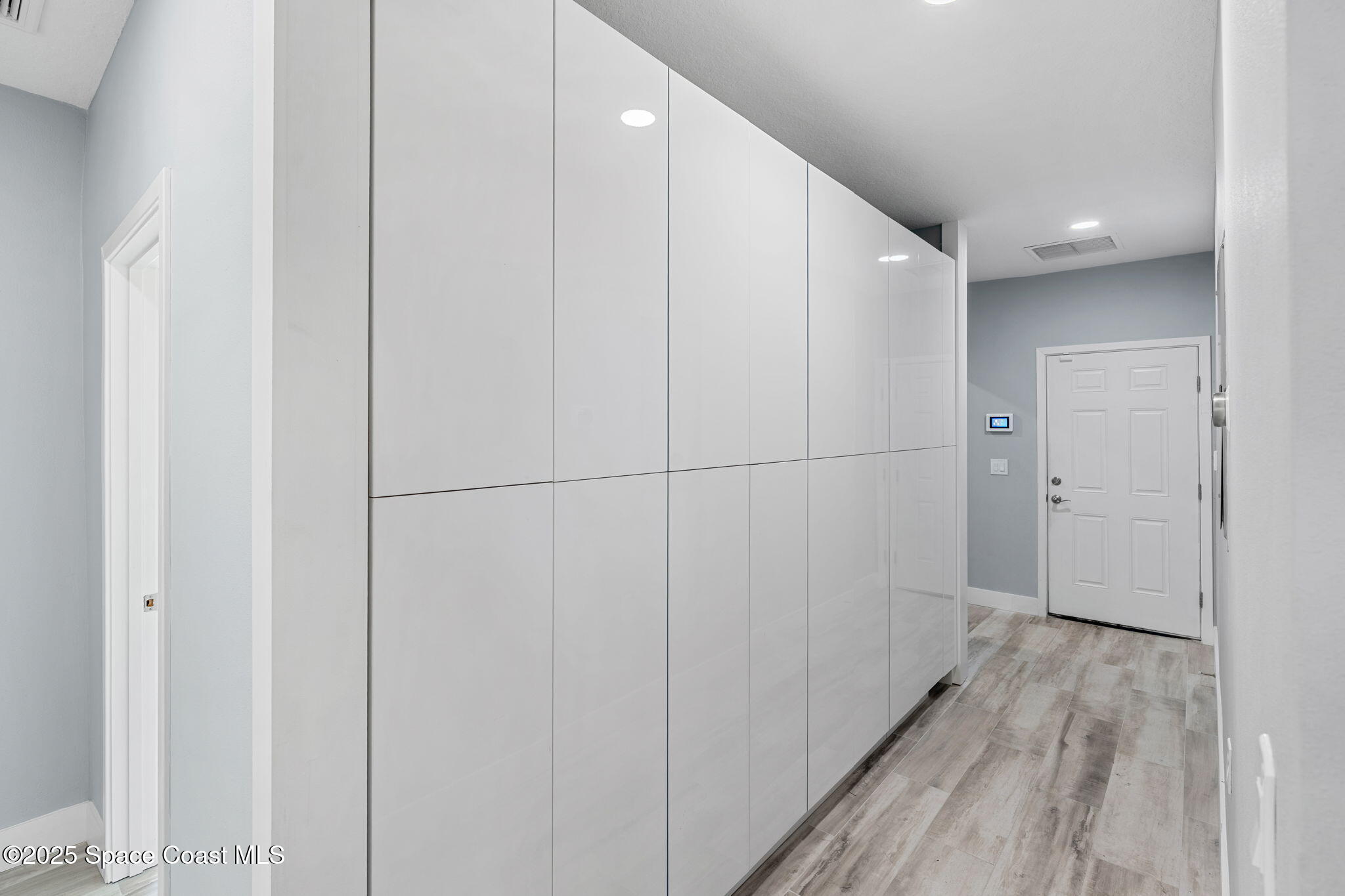 2187 Turtle Mound Road Melbourne, FL 32934 - Photo 44 of 77 a view of a hallway with wooden floor