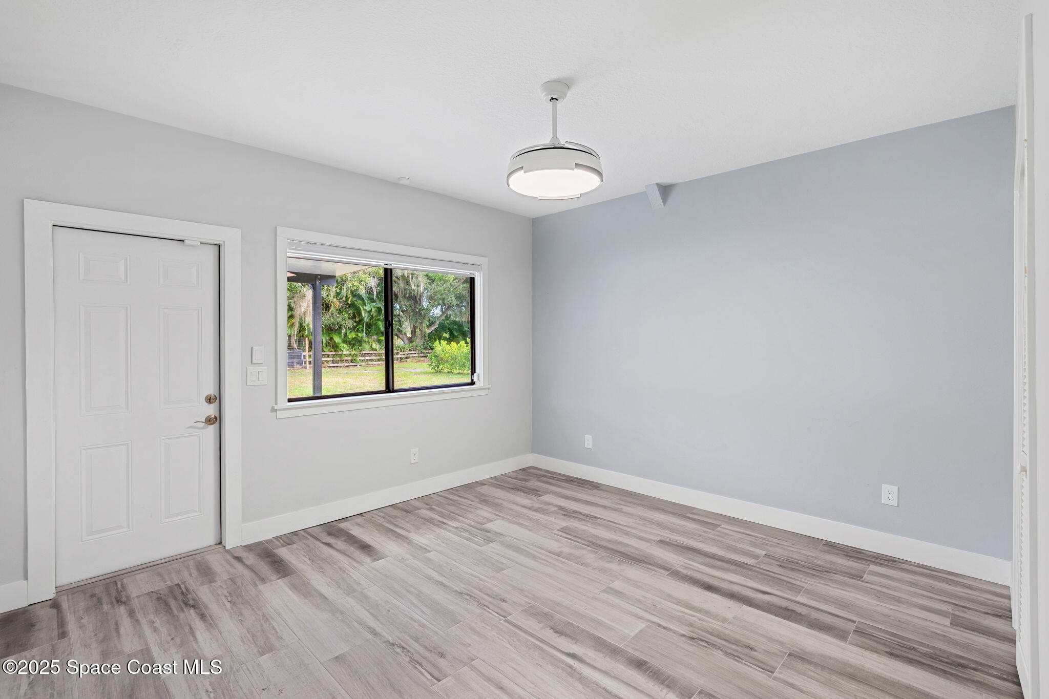 2187 Turtle Mound Road Melbourne, FL 32934 - Photo 45 of 77 wooden floor in an empty room with a window