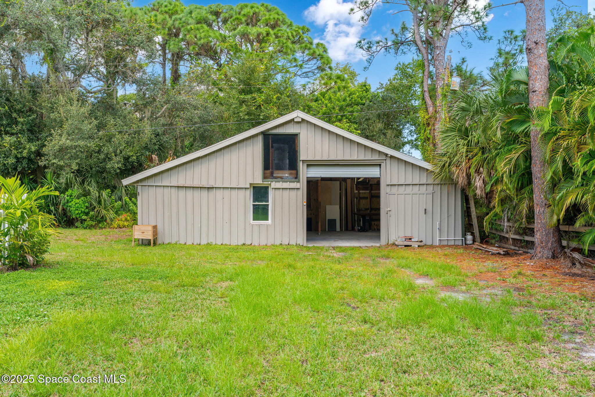 2187 Turtle Mound Road Melbourne, FL 32934 - Photo 63 of 77 a view of a house with backyard and garden