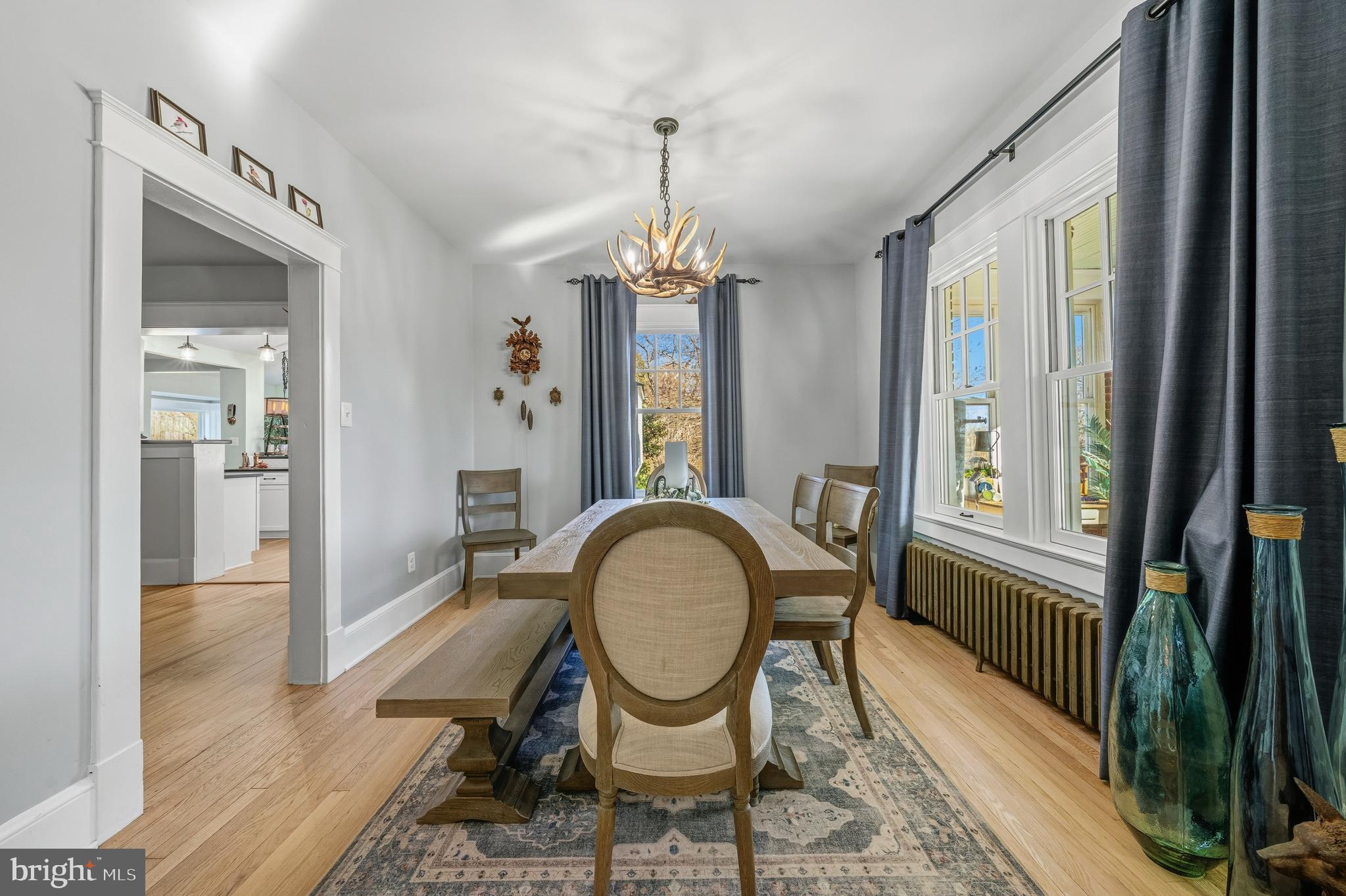 19209 Croom Road Brandywine, MD 20613 - Photo 26 of 95 a dining room with furniture a chandelier and wooden floor