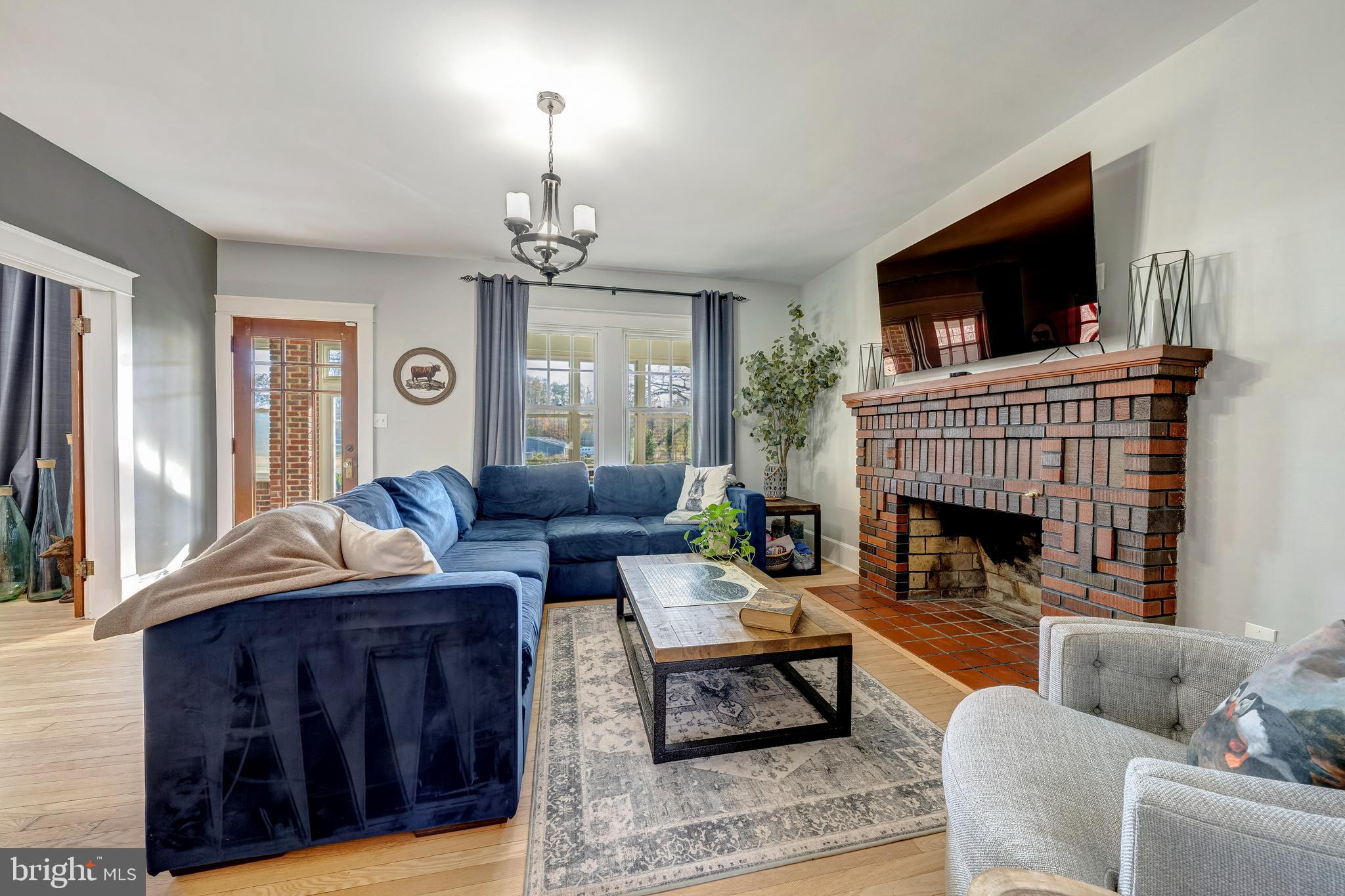 19209 Croom Road Brandywine, MD 20613 - Photo 29 of 95 a living room with furniture a flat screen tv and a fireplace