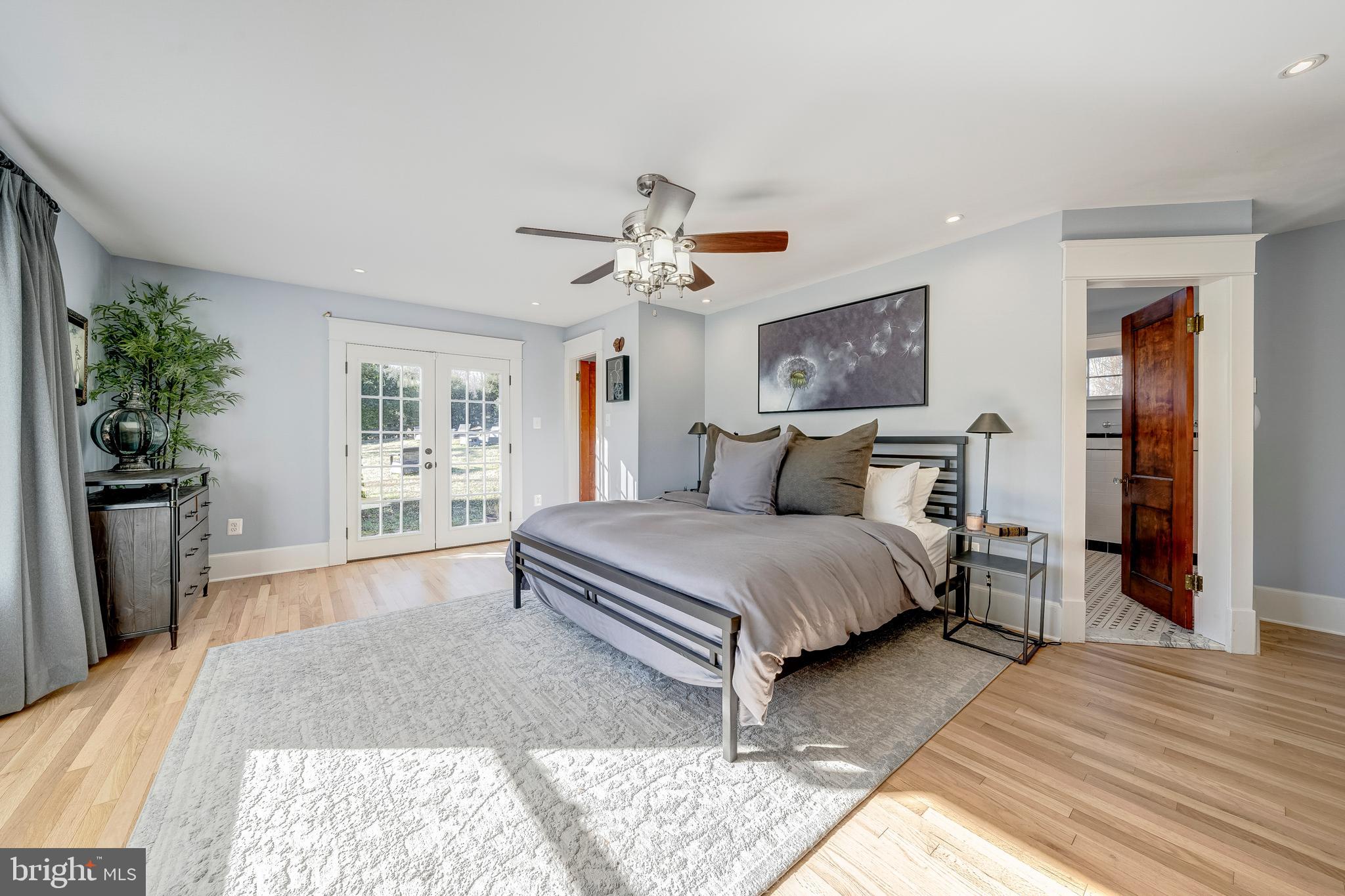19209 Croom Road Brandywine, MD 20613 - Photo 32 of 95 a bedroom with a large bed a chandelier and dresser