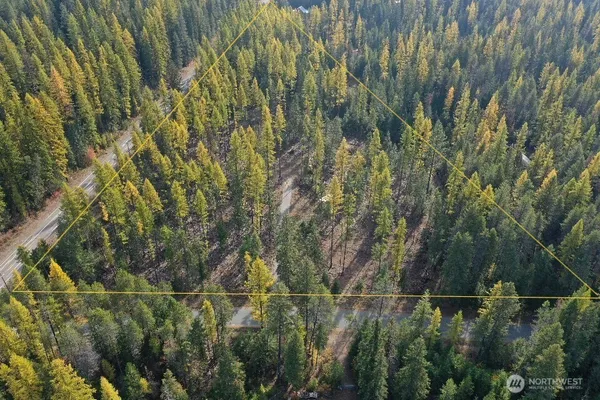 a view of mountains and green field