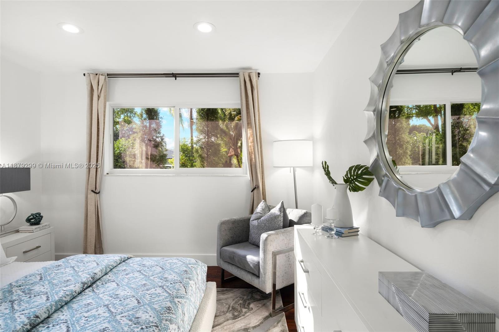 475 Northwest 88th Terrace El Portal, FL 33150 - Photo 19 of 33 a bedroom with a balcony a bed and a chair