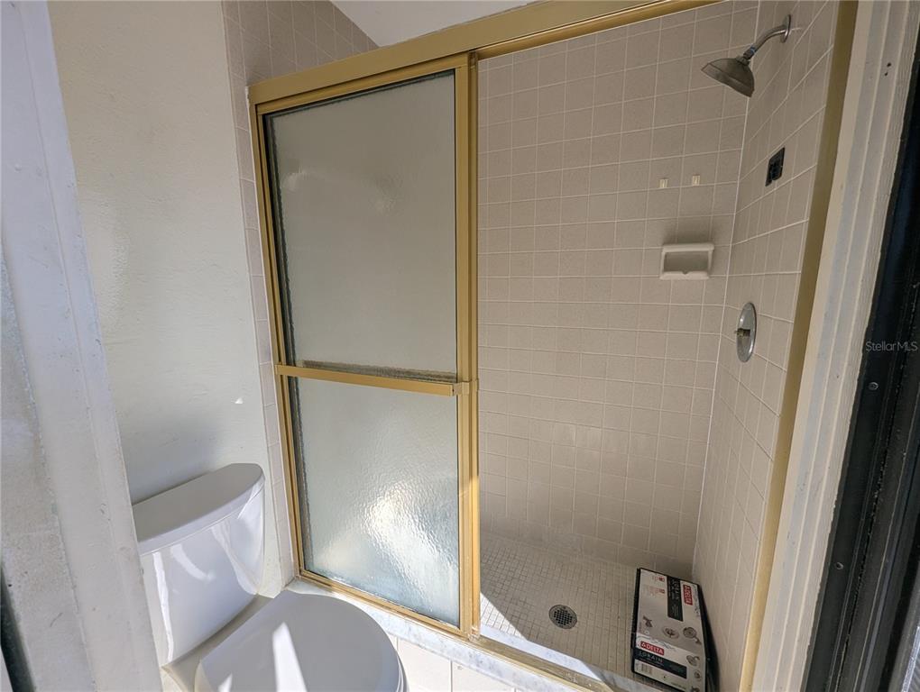 1329 Pine Needle Road Venice, FL 34285 - Photo 15 of 43 a bathroom with a glass door shower