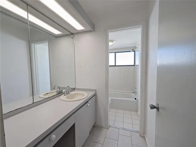 a bathroom with a tub and a shower