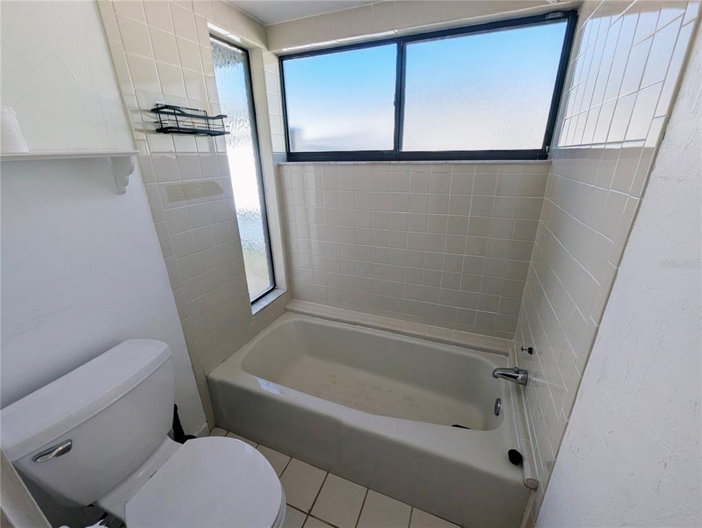 1329 Pine Needle Road Venice, FL 34285 - Photo 19 of 43 a bathroom with a tub and a shower