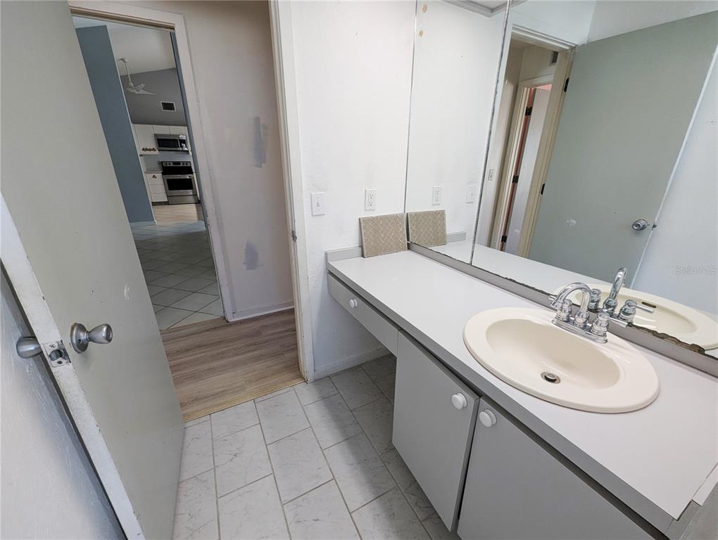 1329 Pine Needle Road Venice, FL 34285 - Photo 20 of 43 a bathroom with a sink and a mirror