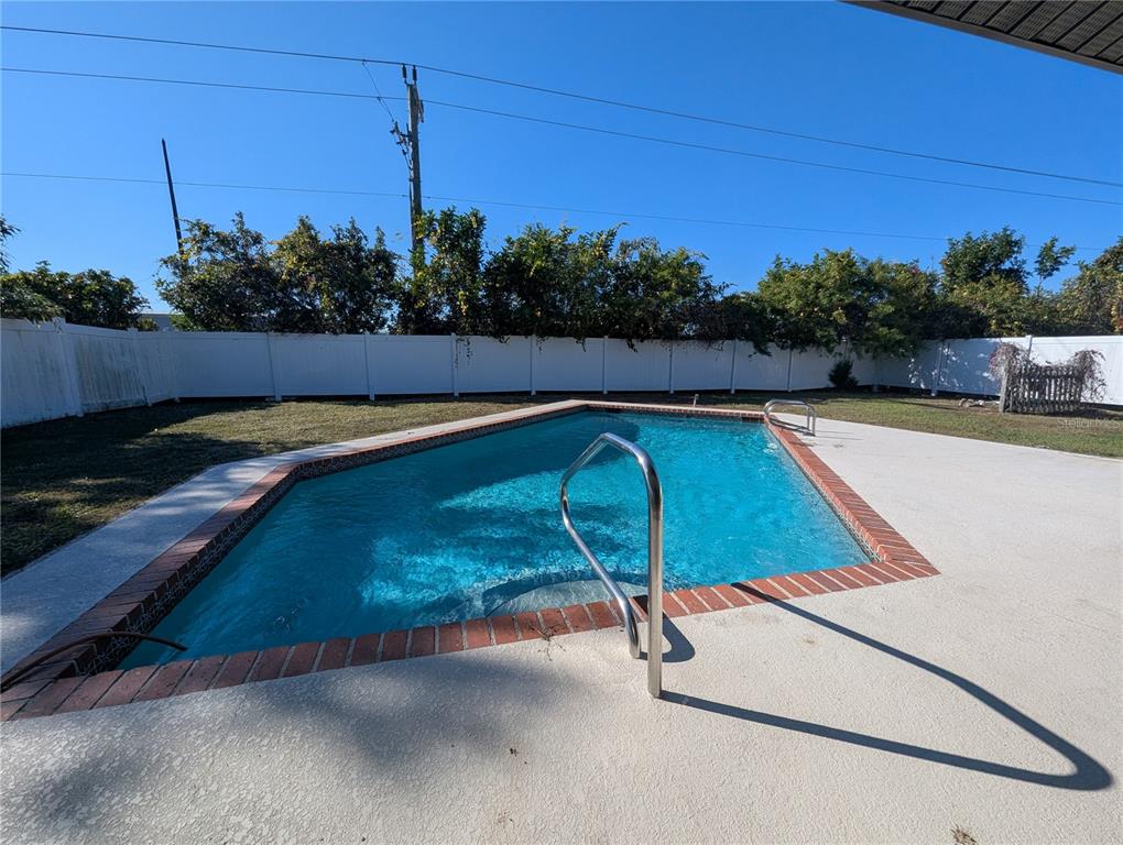 1329 Pine Needle Road Venice, FL 34285 - Photo 34 of 43 a view of a swimming pool with a yard