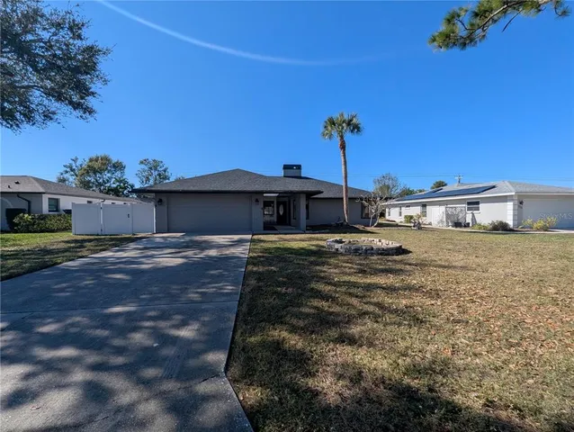 an aerial view of a house with pool and a yard