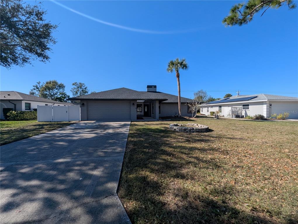 1329 Pine Needle Road Venice, FL 34285 - Photo 36 of 43 a front view of a house with a yard