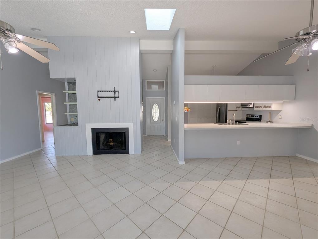 1329 Pine Needle Road Venice, FL 34285 - Photo 4 of 43 a living room with furniture and a fireplace