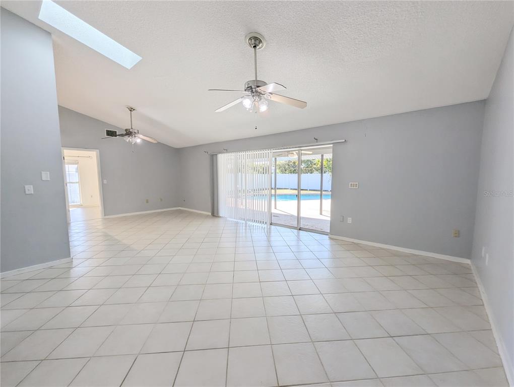 1329 Pine Needle Road Venice, FL 34285 - Photo 9 of 43 an empty room with windows and ceiling fan