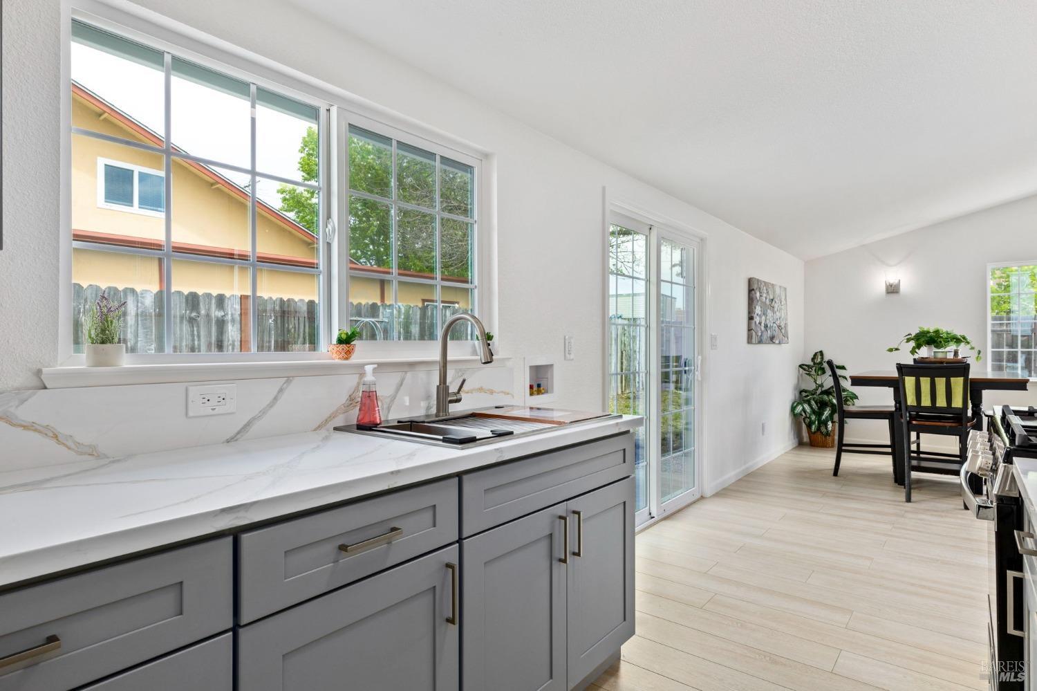 240 Rinaldo Drive Vallejo, CA 94589 - Photo 15 of 41 a open hall with stainless steel appliances granite countertop a coffee table and a large window with wooden floor