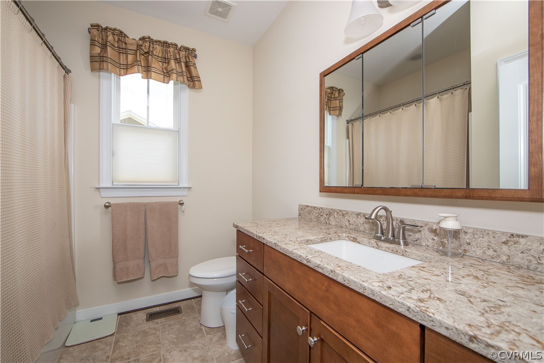 163 Button Bush Road Richmond, VA 23238 - Photo 31 of 46 a bathroom with a granite countertop sink toilet and mirror