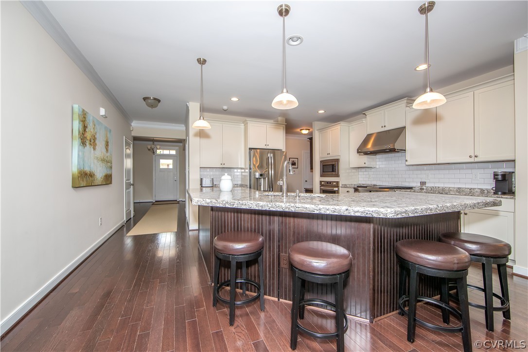 163 Button Bush Road Richmond, VA 23238 - Photo 10 of 46 a kitchen with stainless steel appliances granite countertop a stove a sink a oven a dining table and chairs with wooden floor