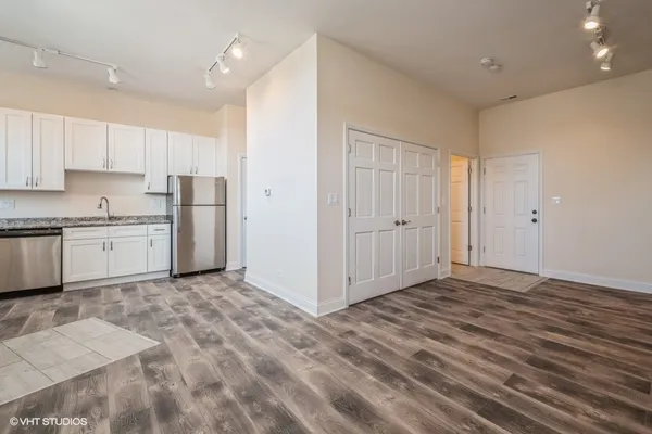 a view of kitchen with wooden cabinets