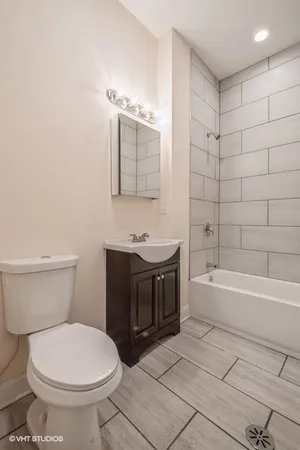 a bathroom with a sink a toilet and bathtub