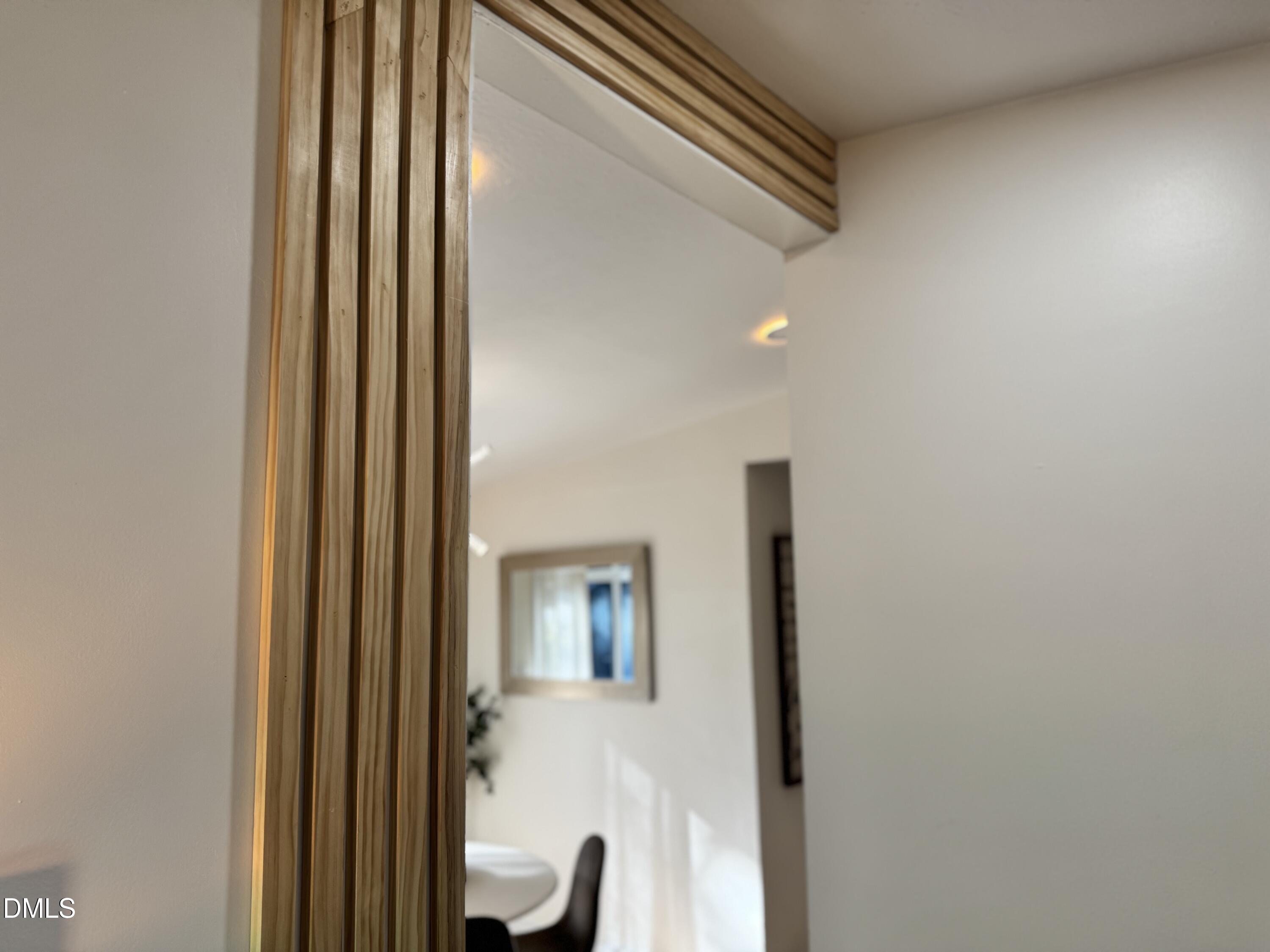 851 Hadley Road Raleigh, NC 27610 - Photo 14 of 46 a view of a hallway with wooden floor and staircase