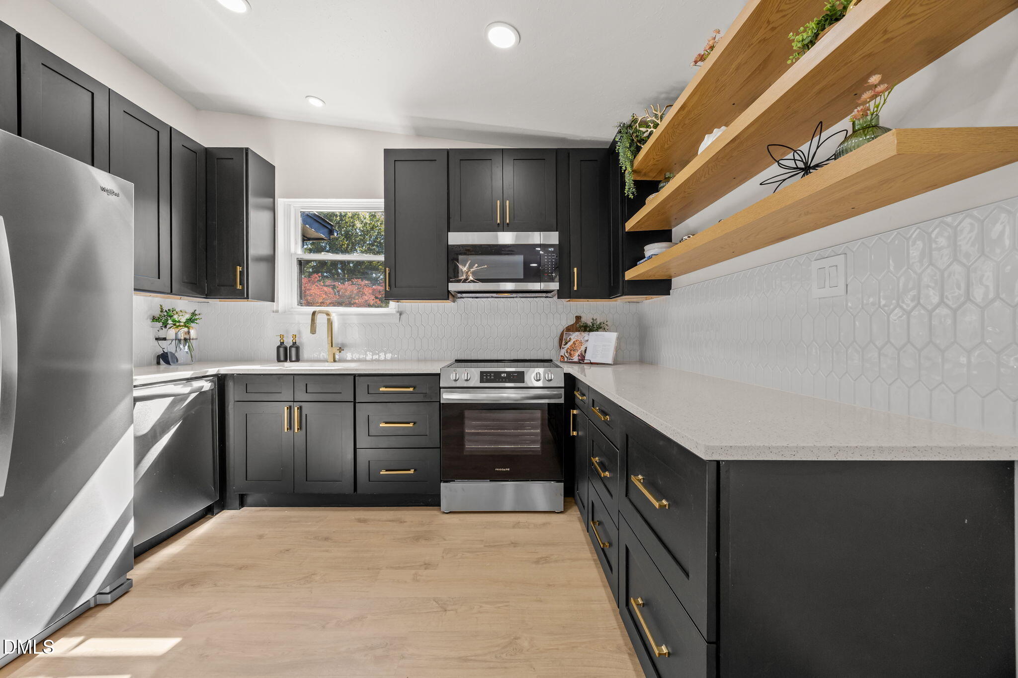 851 Hadley Road Raleigh, NC 27610 - Photo 17 of 46 a kitchen with stainless steel appliances a sink stove and refrigerator
