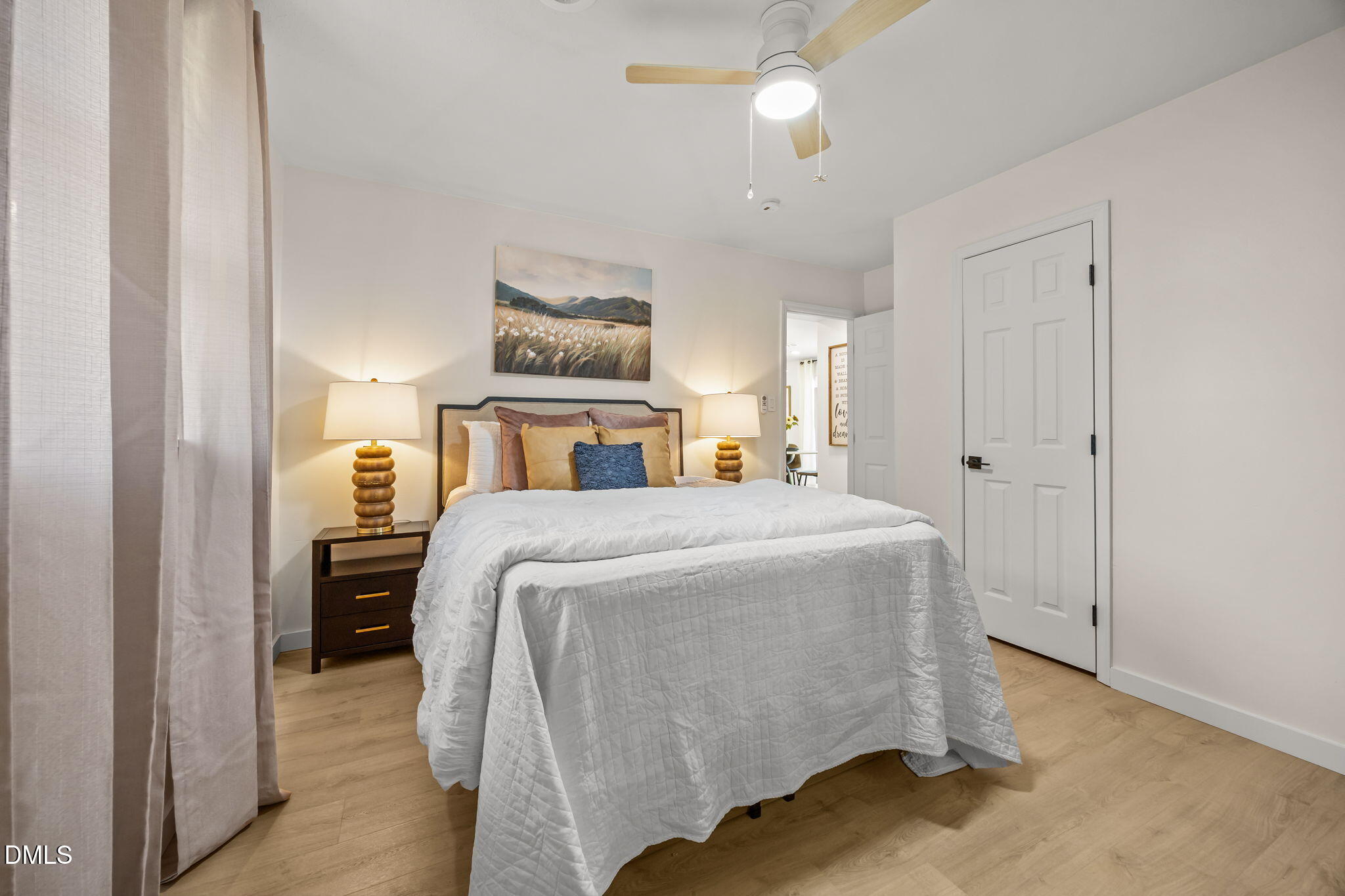 851 Hadley Road Raleigh, NC 27610 - Photo 29 of 46 a bedroom with a large bed and a chandelier
