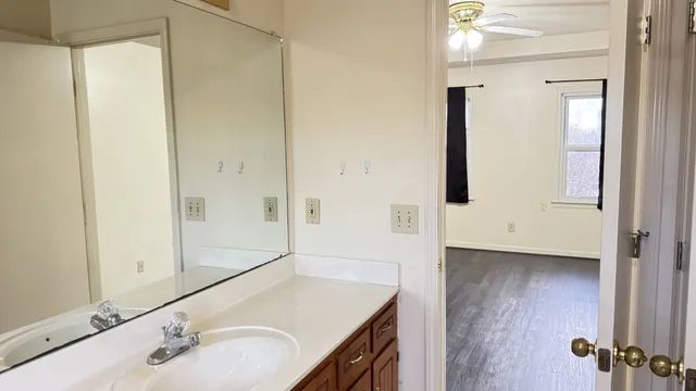 an empty room with window and hardwood floor