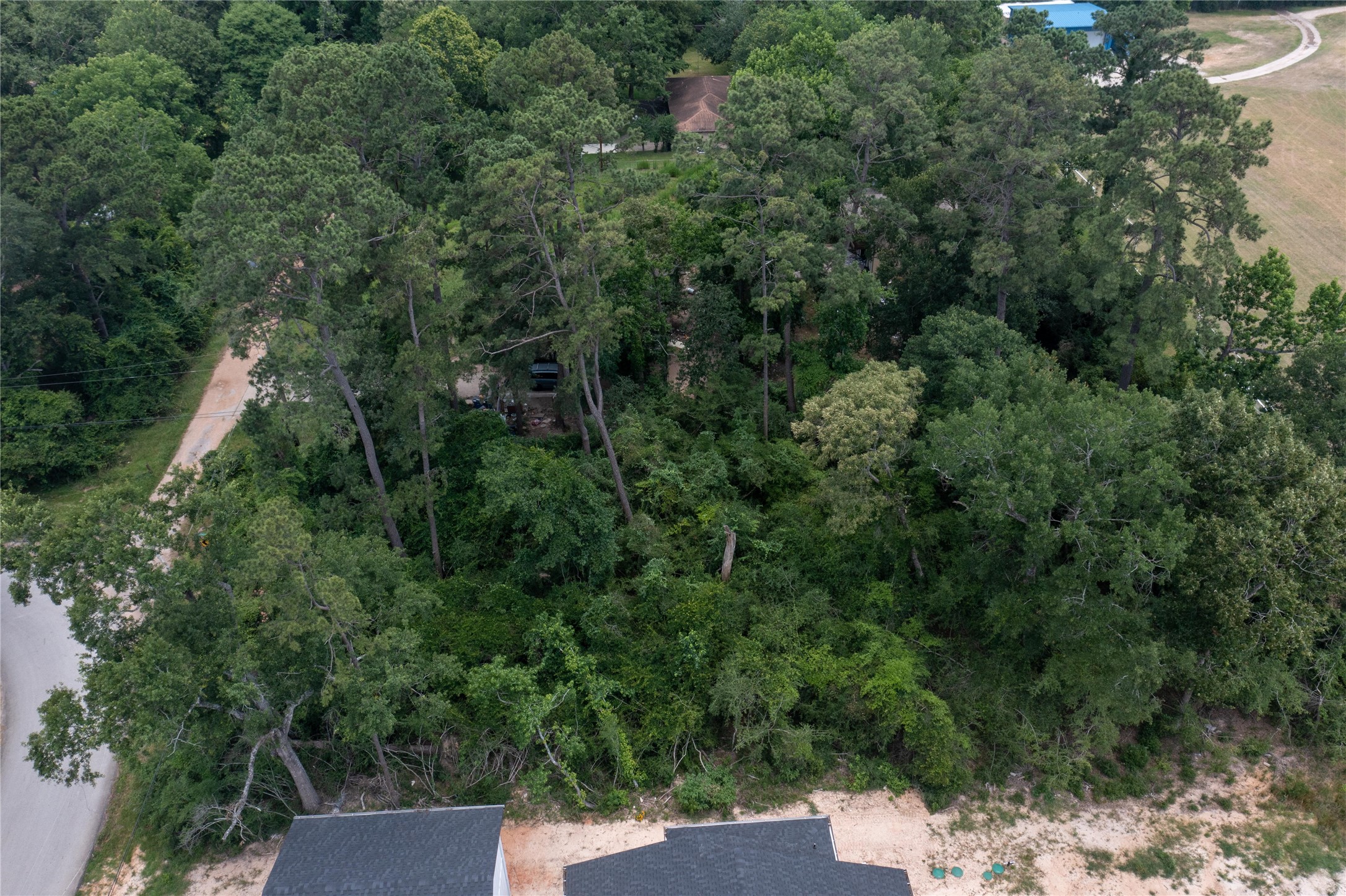 0 East Loop Road Conroe, TX 77384 - Photo 4 of 10 an outdoor view of house with green space