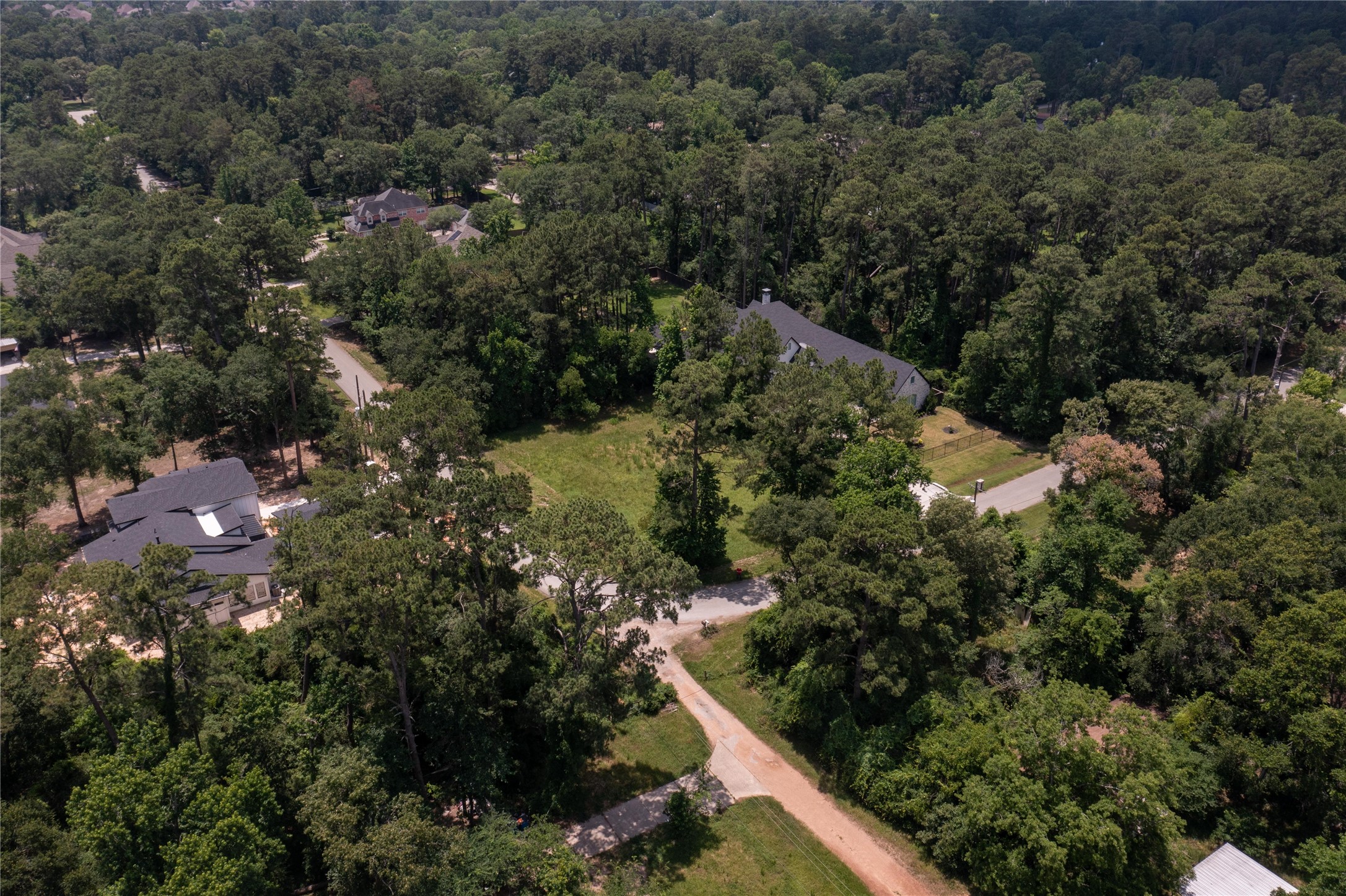 0 East Loop Road Conroe, TX 77384 - Photo 9 of 10 an aerial view of residential house with outdoor space and trees all around