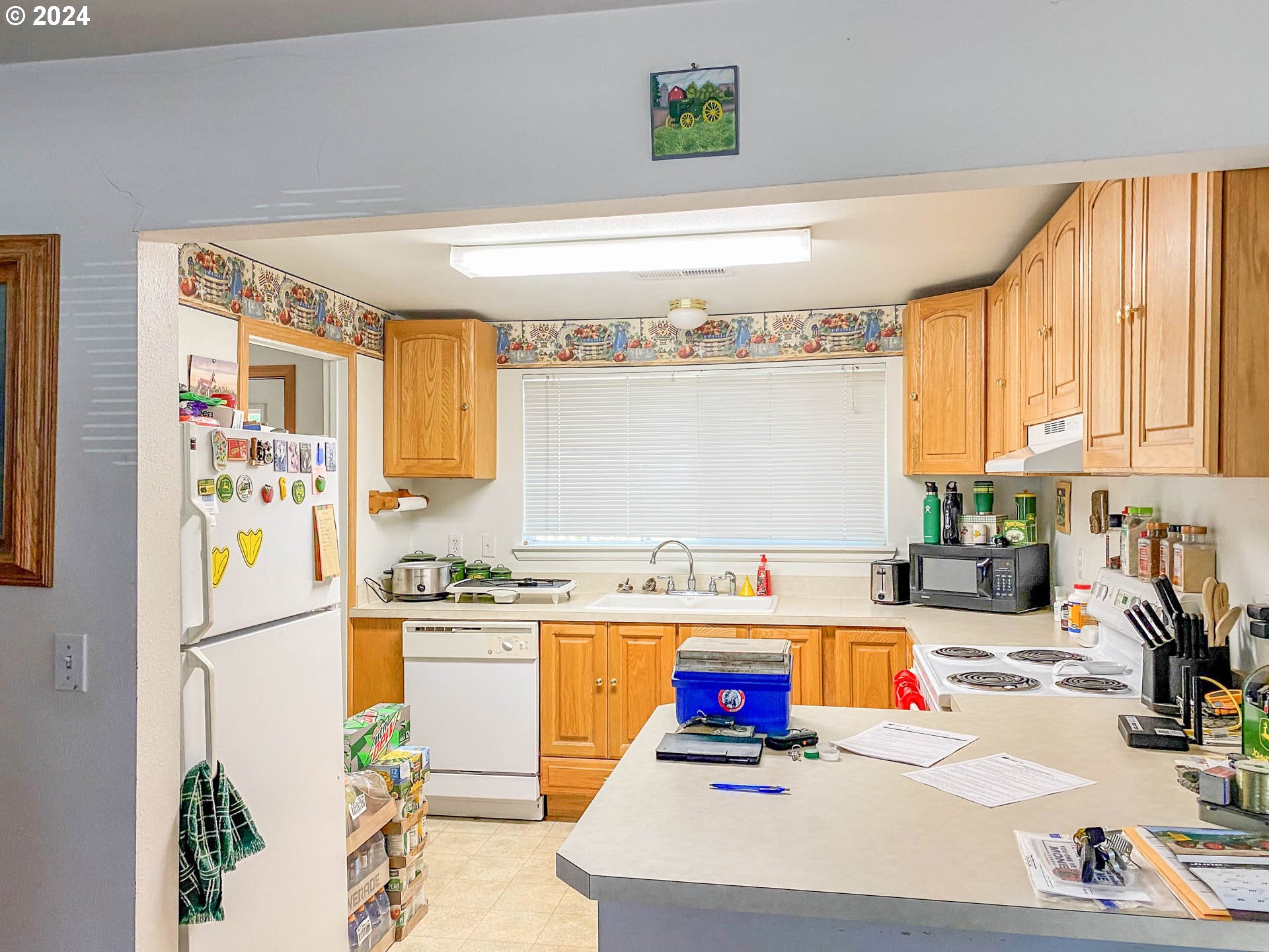 881 Northeast Newton Creek Road Roseburg, OR 97470 - Photo 5 of 11 a kitchen with stainless steel appliances kitchen island wooden cabinets a refrigerator and a sink